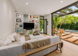 Cozy bedroom with wall art and garden view.