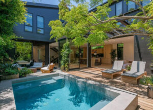 Modern backyard with pool and lounge chairs under a pergola.